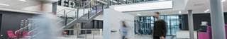Corporate office real estate modern entryway with staff walking