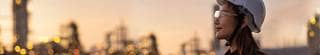 Construction worker in hard hat looking out to the skyline.
