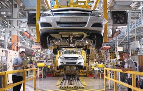 Automobile being assembled in a factory.