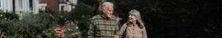 Two senior citizens walking together.